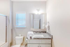 a white bathroom with a sink and a toilet at Cocora on Church Street - B in Myrtle Beach +20 photos