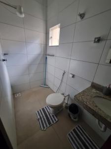 a small bathroom with a toilet and a sink at Casa Aconchegante e Mobiliada in Três Lagoas