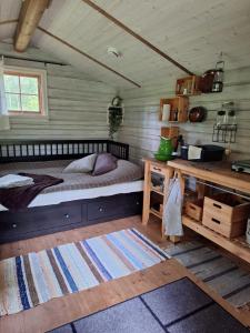 a bedroom with a bed and a desk at Bjärnhultsgårdens stugor in Linderöd