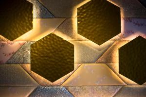 a close up of a wooden wall with lights at 間人温泉 炭平 in Kyotango
