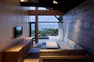 a living room with a couch and a television at 間人温泉 炭平 in Kyotango