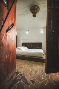 a bedroom with a large bed in a room at Lush Atitl&aacute;n in San Marcos La Laguna