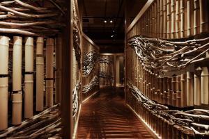 a hallway of a wine cellar with wooden floors at 間人温泉 炭平 in Kyotango