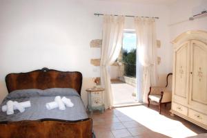 CerfignanoにあるAgriturismo Tenuta Sant'Antonioのベッドルーム(ベッド1台付)、バルコニーが備わります。