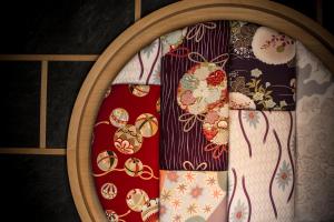 a group of ties in a wooden frame at 間人温泉 炭平 in Kyotango