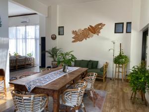 a living room with a wooden table and chairs at Roemah Uli Cirebon in Cirebon