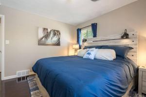 a bedroom with a large bed with a blue blanket at Akron 2 Bed & 1 Bath Close to everything in Akron