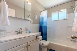 a white bathroom with a sink and a toilet at Akron 2 Bed & 1 Bath Close to everything in Akron +30 photos