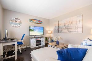 a living room with a white couch and a desk at Akron 2 Bed & 1 Bath Close to everything in Akron