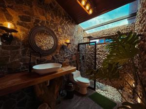 a bathroom with a sink and a toilet at Pika 02 by Pika cabins con Piscina privada in San Carlos