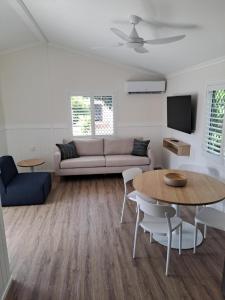 a living room with a couch and a table at Cape Hillsborough Nature Tourist Park in Seaforth