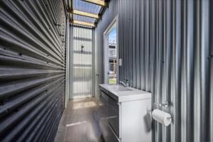 a bathroom with a toilet and a sink at Bombora in Arrawarra +17 photos