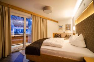 a bedroom with a large bed and a window at Apartment in Gerlos - Zillertal 49996 in Gerlos