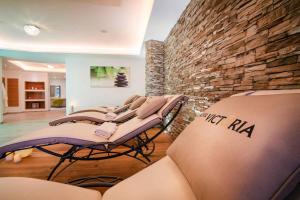 a row of massage chairs in a room with a brick wall at Apartment in Gerlos - Zillertal 49996 in Gerlos