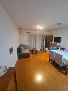 a living room with a table and a couch at Apartments with parking space Cizici, Krk - 15415 in Malinska