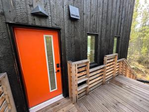 an orange door on a building with a deck at Black Spruce - Orange Door in Whitehorse +22 photos