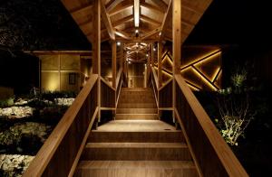a staircase leading up to a building at night at 間人温泉 炭平 in Kyotango