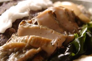 a plate of food with meat and vegetables at 間人温泉 炭平 in Kyotango