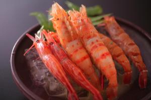 a group of carrots sitting on a plate at 間人温泉 炭平 in Kyotango