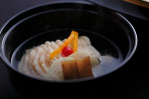 a bowl of food with carrots and pasta at 間人温泉 炭平 in Kyotango