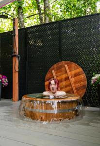 a woman sitting in a chair in a fountain at Purple City Retreats - Luxury Yurt & Spa in Portland
