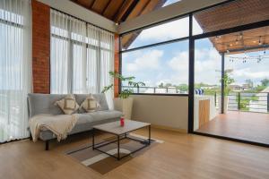 una sala de estar con un sofá y una mesa en Luxury Casa White Palmera, en Uluwatu
