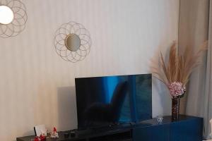 a tv sitting on top of a blue cabinet at Stunning Apartment in heart of Dambach La Ville in Dambach-la-Ville