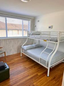a bedroom with two bunk beds in a room at Beachside Apartment Blackwoods Beach in Cronulla