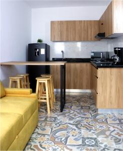 a kitchen with a couch and a counter with stools at Hotel Ambar La Morada in Buga +16 photos