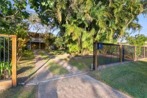 a gate in front of a yard with palm trees at Edmund Street 47, Shelly Beach in Caloundra
