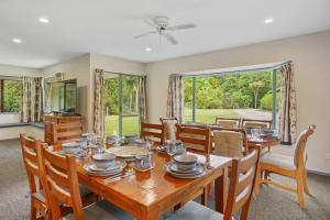 a dining room with a wooden table and chairs at Family Hideaway in Hanmer Springs