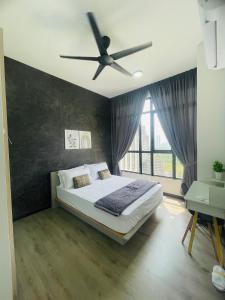 a bedroom with a bed with a ceiling fan at HARRAZ SUITE PUTRAJAYA just minutes away from PICC and KPT perfect for both business and leisure stays in Putrajaya