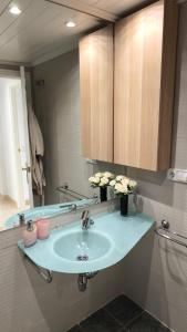 a bathroom with a sink and a mirror at Las Jacarandas Penthouse with Stunning Views & Private Rooftop in Benahavís