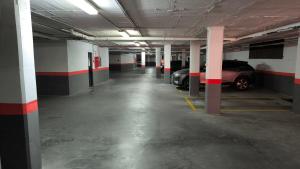 an empty parking garage with cars parked in it at Las Jacarandas Penthouse with Stunning Views & Private Rooftop in Benahavís