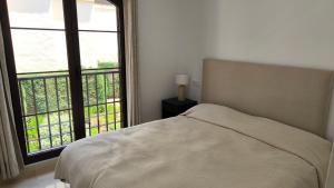 a bedroom with a bed and a large window at Las Jacarandas Penthouse with Stunning Views & Private Rooftop in Benahavís