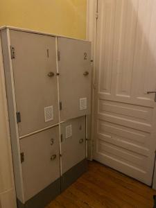 a group of lockers in a room with a door at Hostel Home in Mexico City