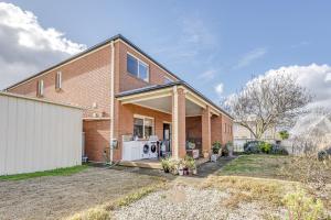 a brick house with a washing machine in the yard at StayAU Family Home Comfort in Caroline Springs in Caroline Springs