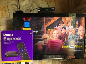 a tv sitting on a shelf with a remote control at El Refugio de los Ángeles in San Antonio del Tequendama