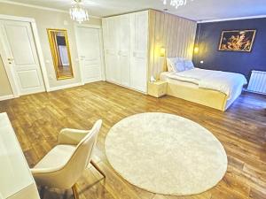a bedroom with a bed and a table and chairs at Luxury villa with sea view 1min to beach in Varna City