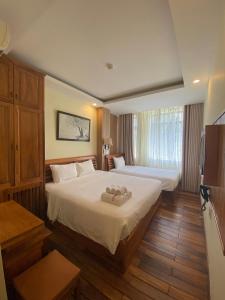 Postel nebo postele na pokoji v ubytování Senkotel Nha Trang Managed by NEST Group