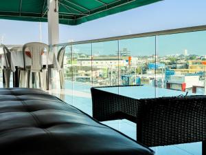 a room with a table and chairs and a large window at Hotel bazurto plaza in Cartagena de Indias