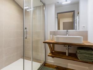 a bathroom with a sink and a shower at Ancien corps de ferme rénové avec jardin, terrasse et recharge EV, à 24 km de Nantes - FR-1-306-1282 in Saint-Colomban