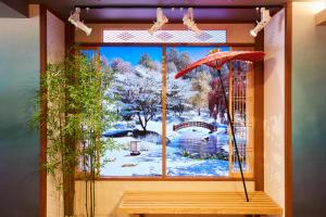 a window with a view of a winter scene at MONday Apart Premium Asakusa in Tokyo