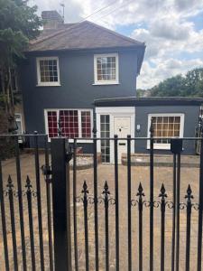 a black fence in front of a blue house at Signet Luxury 3-bedrooms, 2bathrooms House with WiFi & Netflix in Rochester