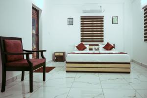 Postel nebo postele na pokoji v ubytování Hotel Gold Suite, Kakkanad