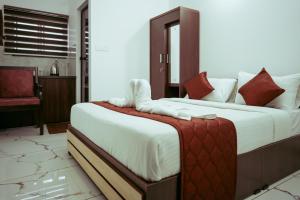 Postel nebo postele na pokoji v ubytování Hotel Gold Suite, Kakkanad