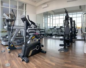 a gym with treadmills and elliptical machines at Nuvasa Bay Studio Apartment 6A10 in Nongsa