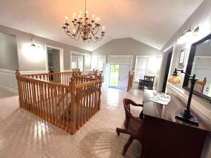 a large living room with a chandelier and a table at Leslie in Wasaga Beach