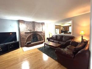 a living room with a couch and a fireplace at Leslie in Wasaga Beach