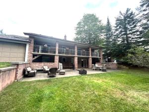 a large house with a patio and a balcony at Leslie in Wasaga Beach